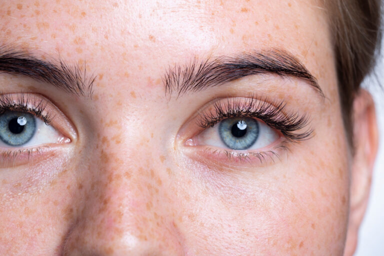 A Close Up Of A Person With Blue Eyes And Think Long Eyelashes