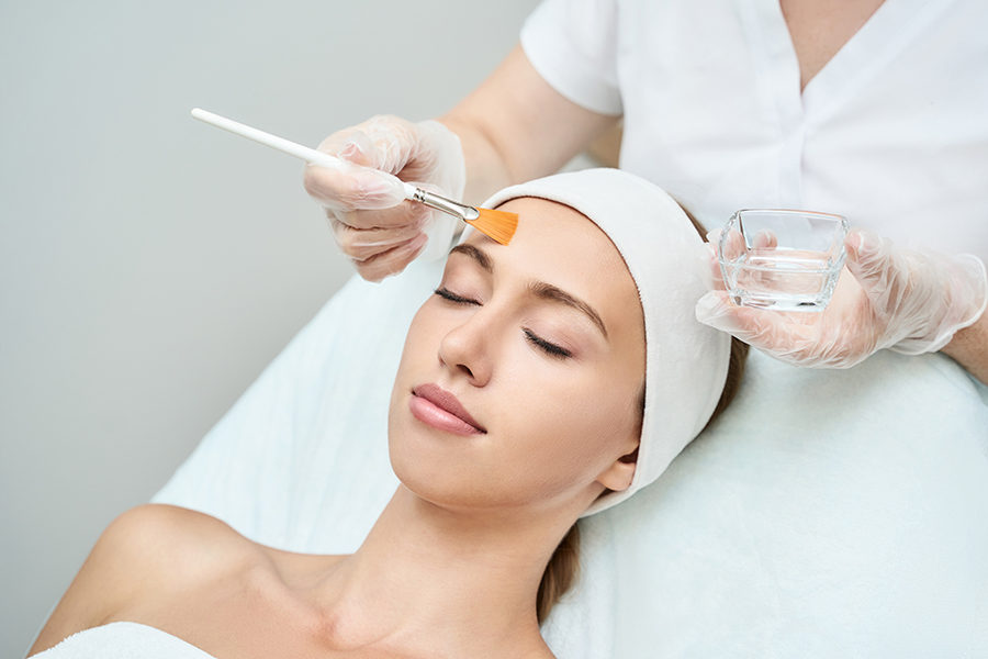 Woman Receiving Facial Chemical Peel Therapy At Coachlight