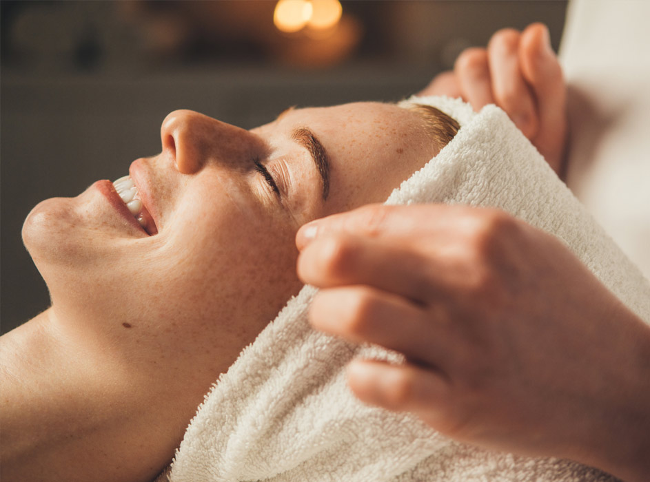 Close-Up Portrait Of A Woman Getting Face Massage In Spa Salon. Doctor Hands. Pretty Female Patient. Beauty Treatment. Healthy Skin Procedure. Young Woman Head