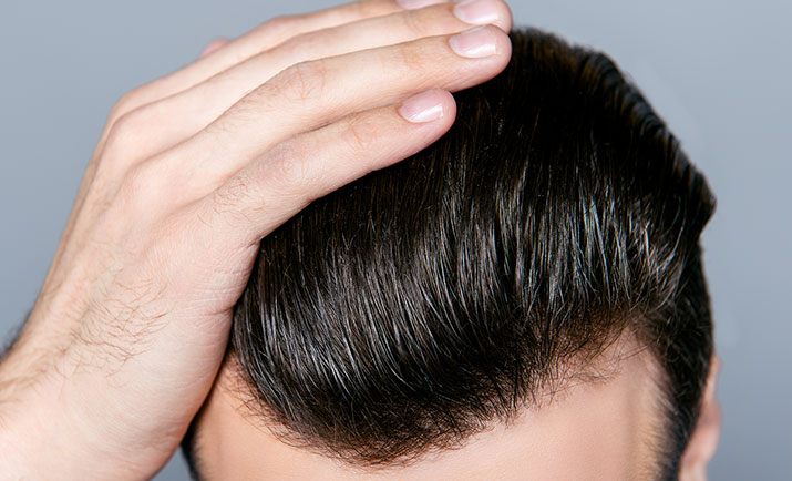 Close Up Photo Of Man Combing His Hair With Fingers