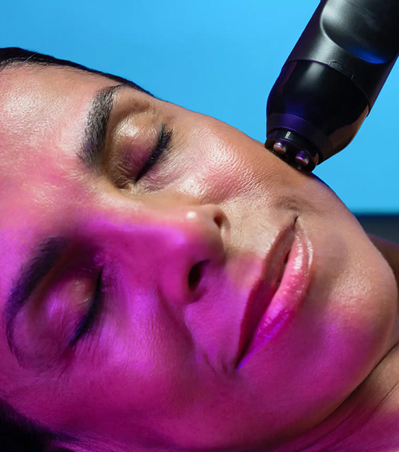 Customized Facials 14 A Woman With Her Eyes Closed And A Glo2Facial Pen On Her Face
